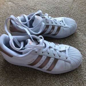 Adidas Superstar with rose gold trim.
